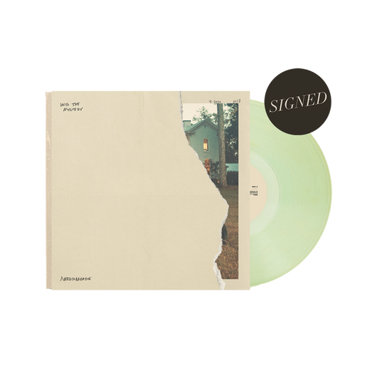 A signed limited edition vinyl record titled 'Into The Mystery' with a coke bottle green color, alongside its packaging with a alternate cover.