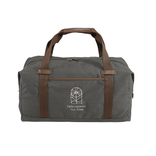 A gray canvas duffle bag with brown handles and a front pocket, featuring a mystery tour logo.