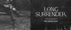 Album cover for 'The Long Surrender' with a person sitting on a bench holding flowers.