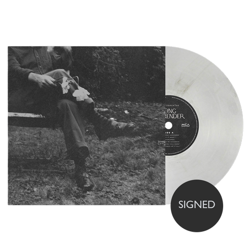 Vinyl record with a person sitting in nature and a 'SIGNED' label.