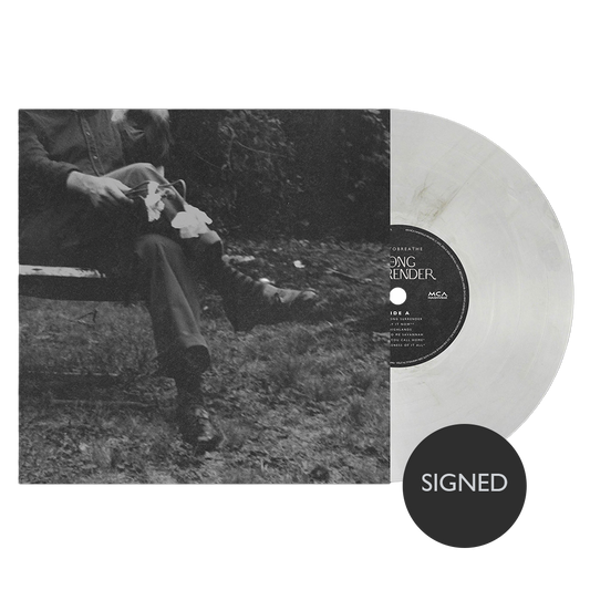 Vinyl record with a person sitting in nature and a 'SIGNED' label.